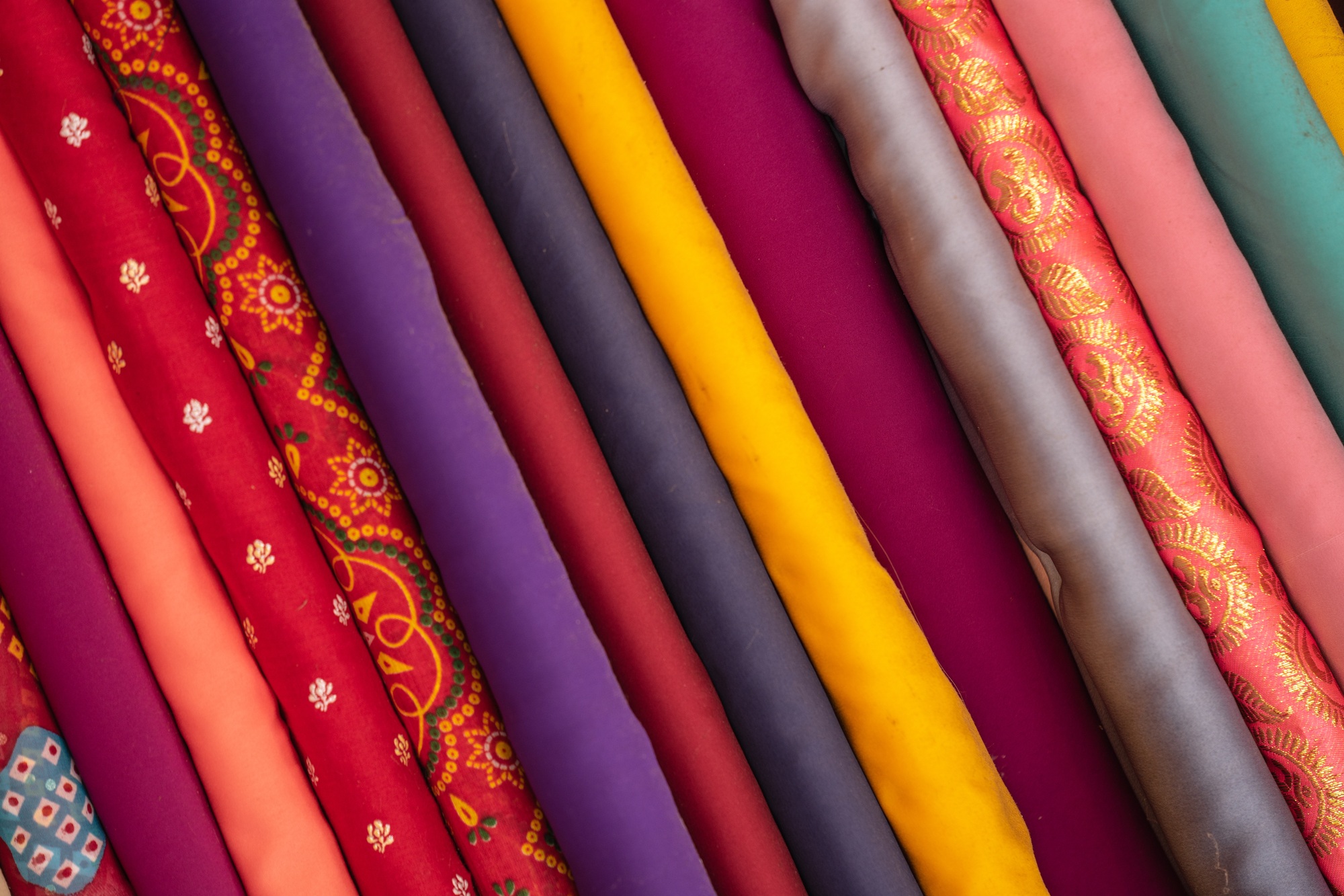 Bright colored fabrics on the shelves in the shop window